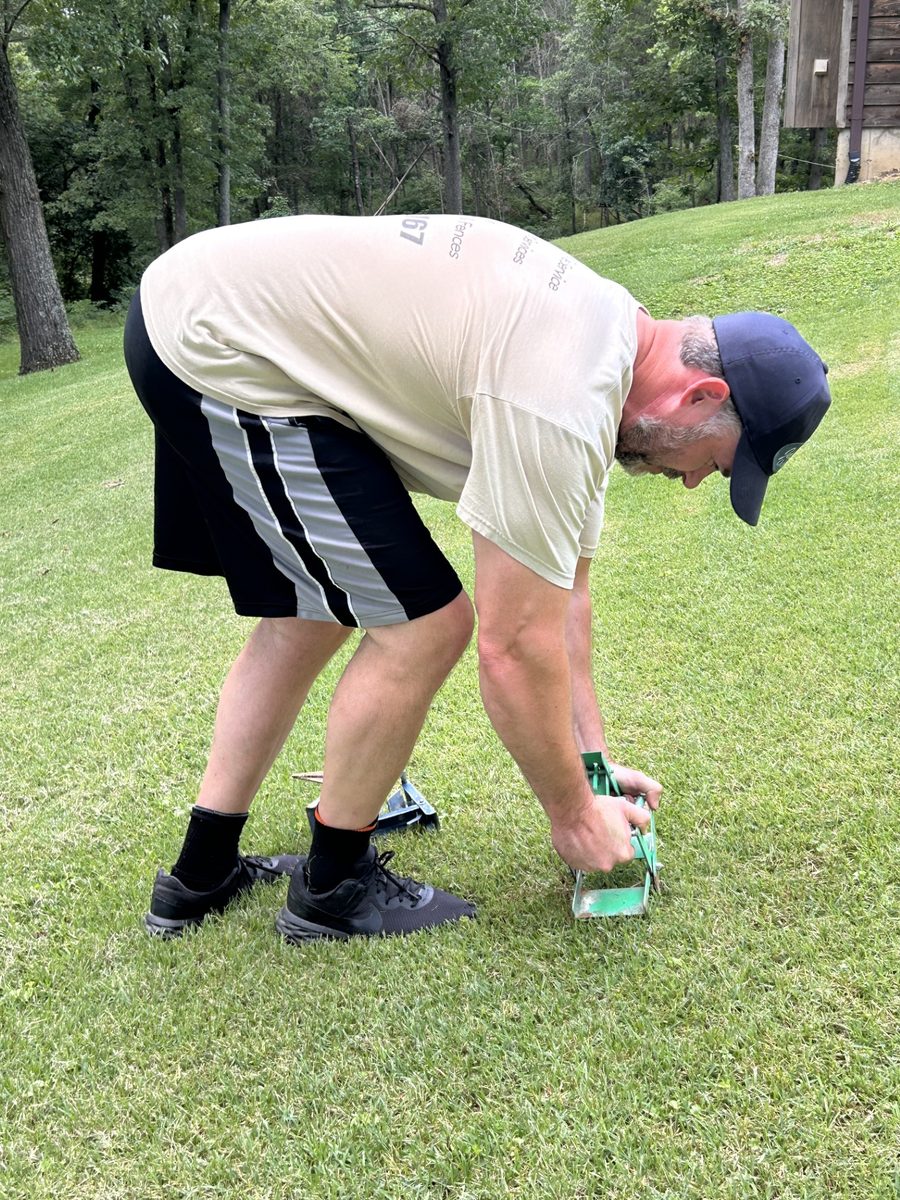 Curt setting a mole trap in a customer's yard
